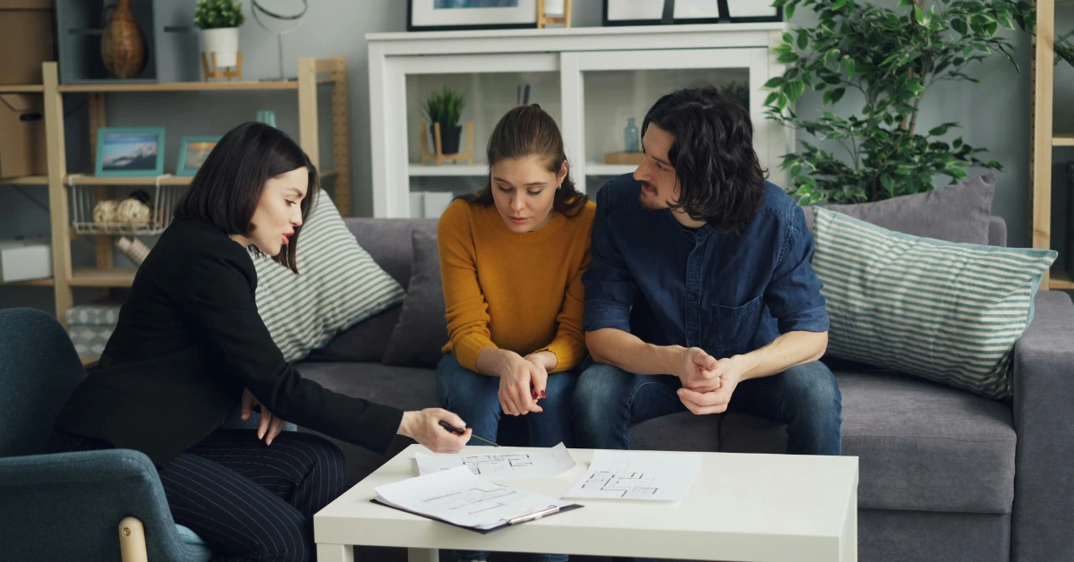 A Couple and a Real Estate Agent Looking at Documents A Couple and a Real Estate Agent Looking at Documents