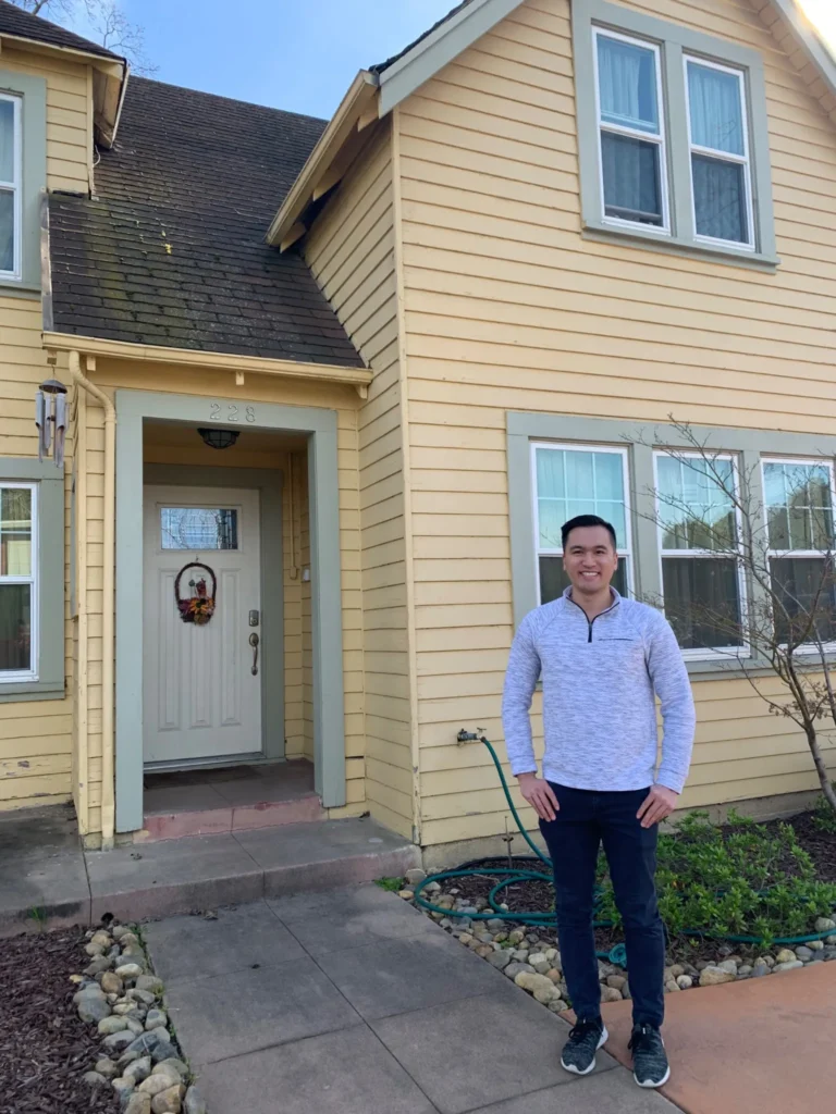 Ryan Chaw in front of rental property
