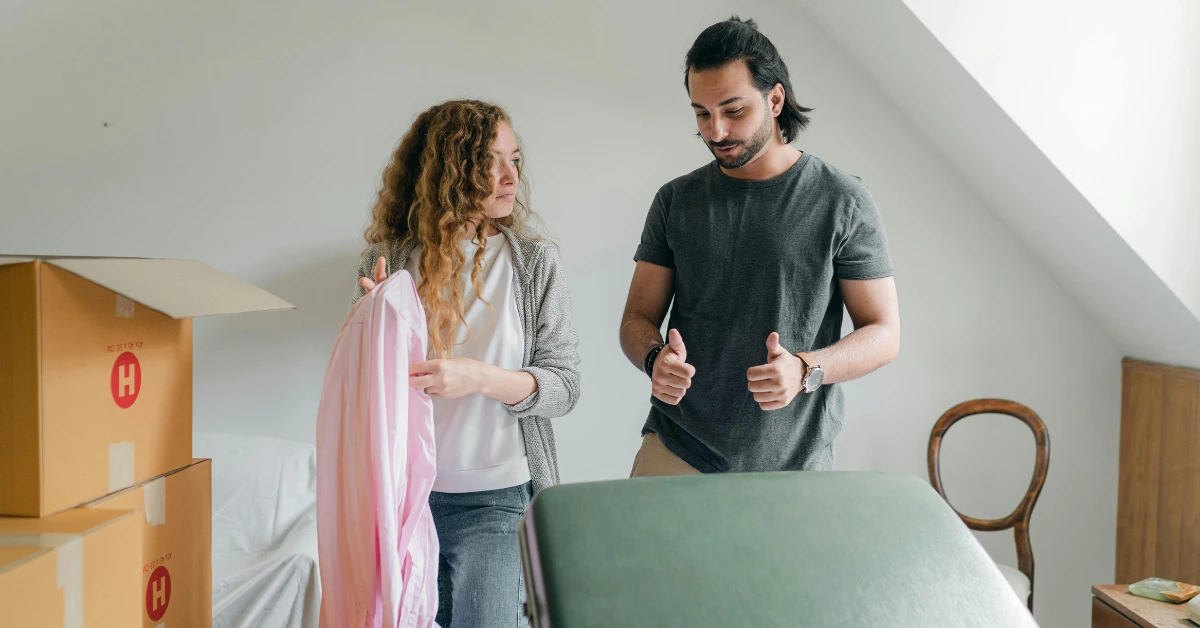 couple packing belongings in carton boxes