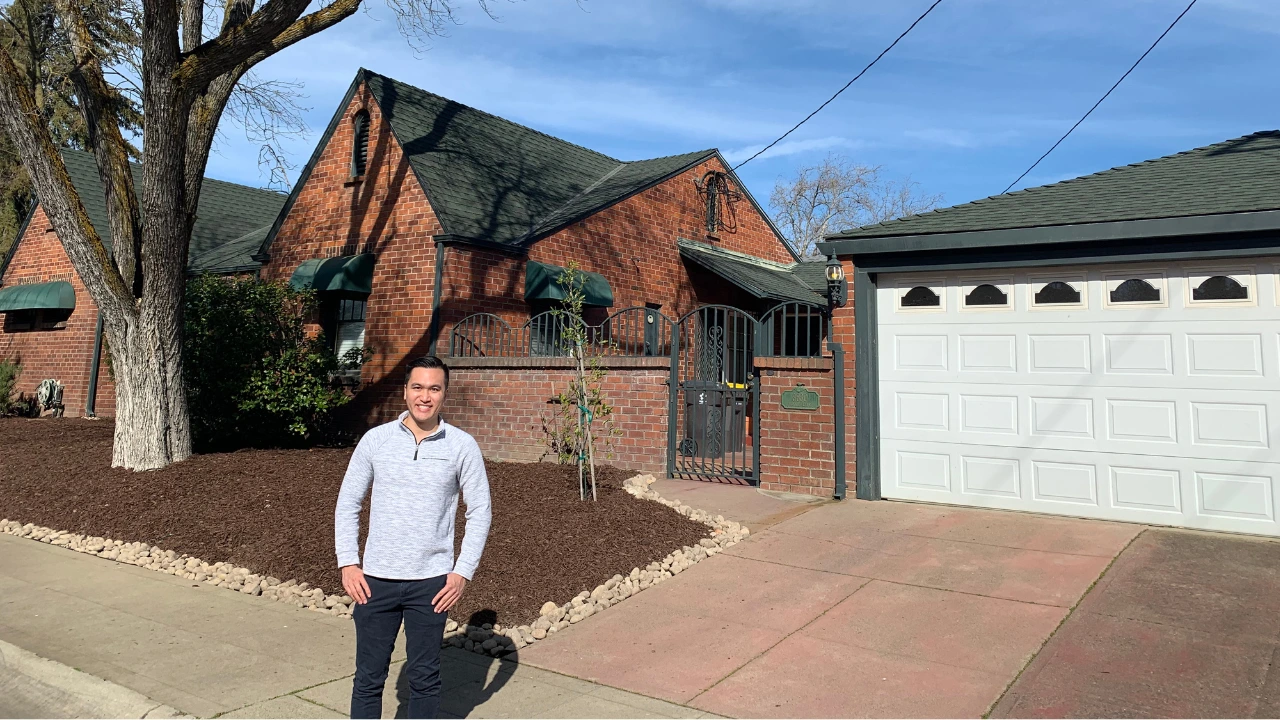 Ryan Chaw standing in front of a student housing rental property he underwrites for profit analysis